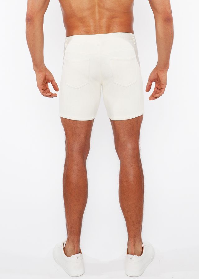 White jaquard stretch knit chino shorts with a sleek form-fitting design and subtle stitching details
