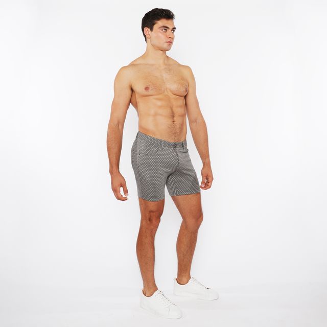 Gray jaquard stretch knit chino shorts with subtle white polka dots, classic tailored fit, and button closure