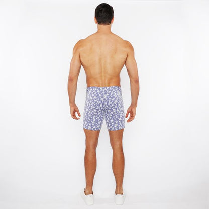 Jaquard stretch knit shorts featuring blue and white floral patterned swim trunks made from stretchy knit fabric