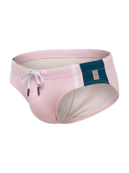 Pink jor 2384 wind swim briefs with navy blue panel white stripe and branded tag on the side for men