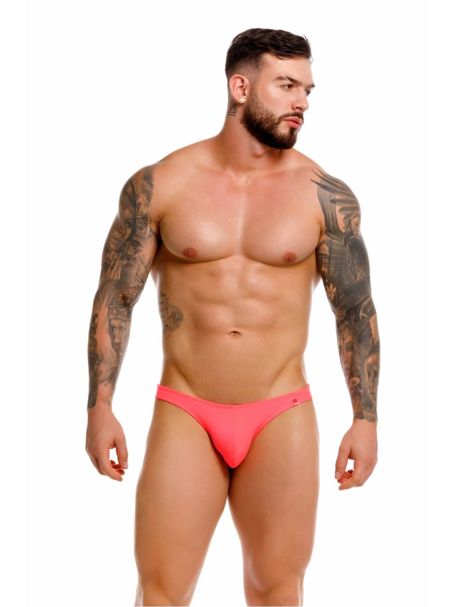 Bright pink form-fitting travel swim thong briefs with subtle brand logo on the side in color candy