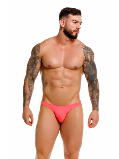 Bright pink form-fitting travel swim thong briefs with subtle brand logo on the side in color candy
