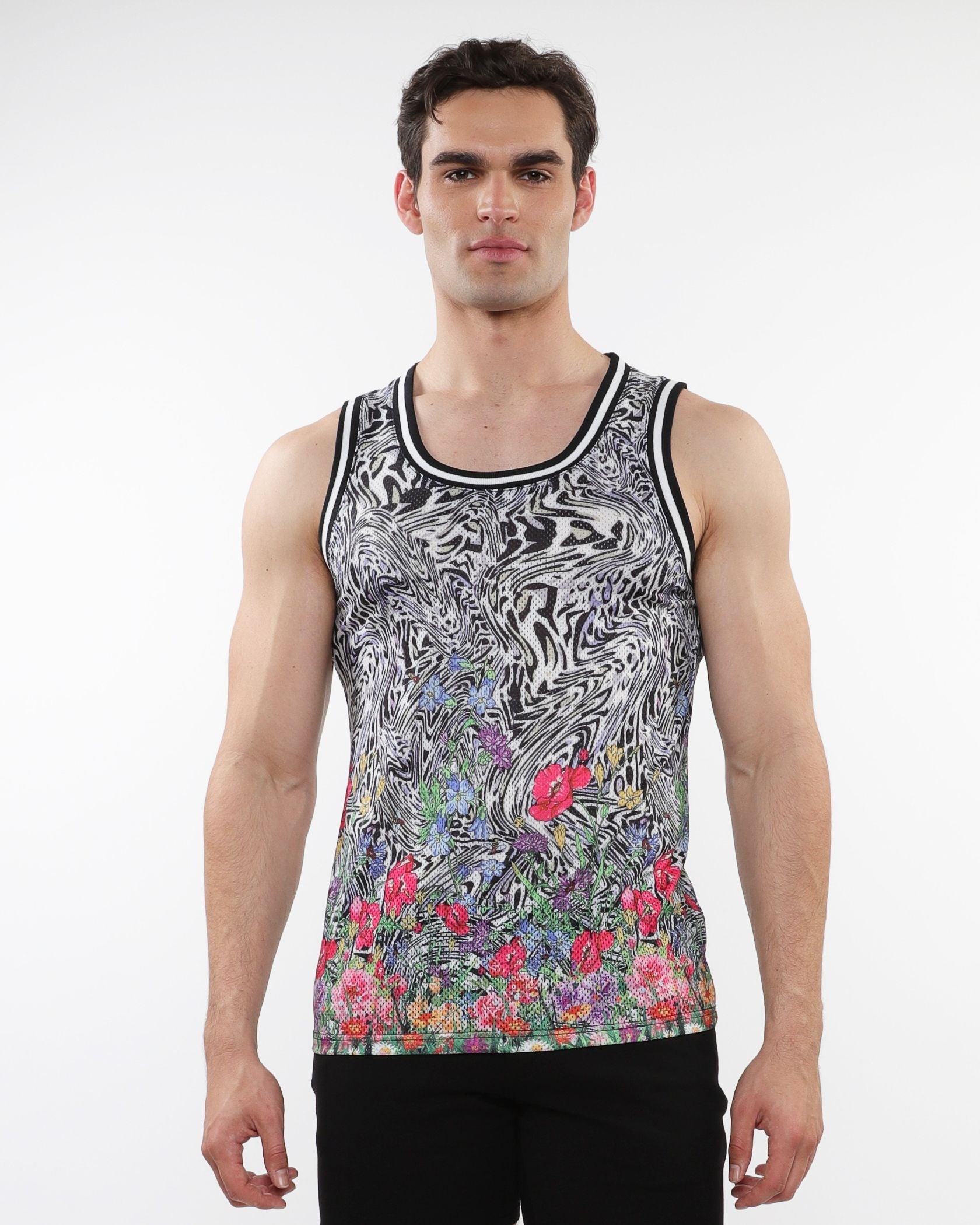 Black and white abstract patterned jungle printed mesh tank with stripe ribbing and vibrant floral accents at the hem