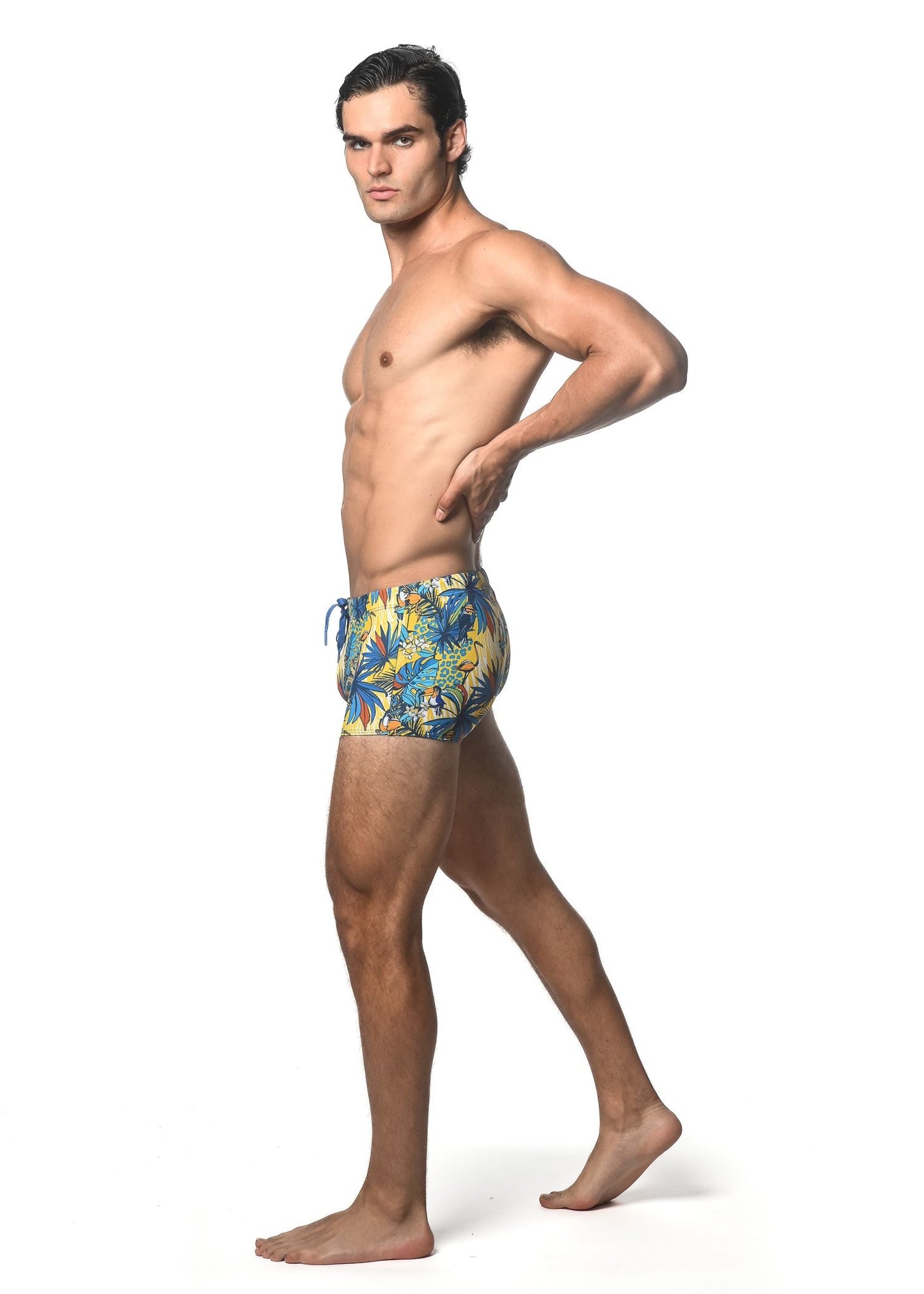 Men’s jungle printed swim trunk with vibrant tropical leaf pattern in blue yellow and green for beachwear