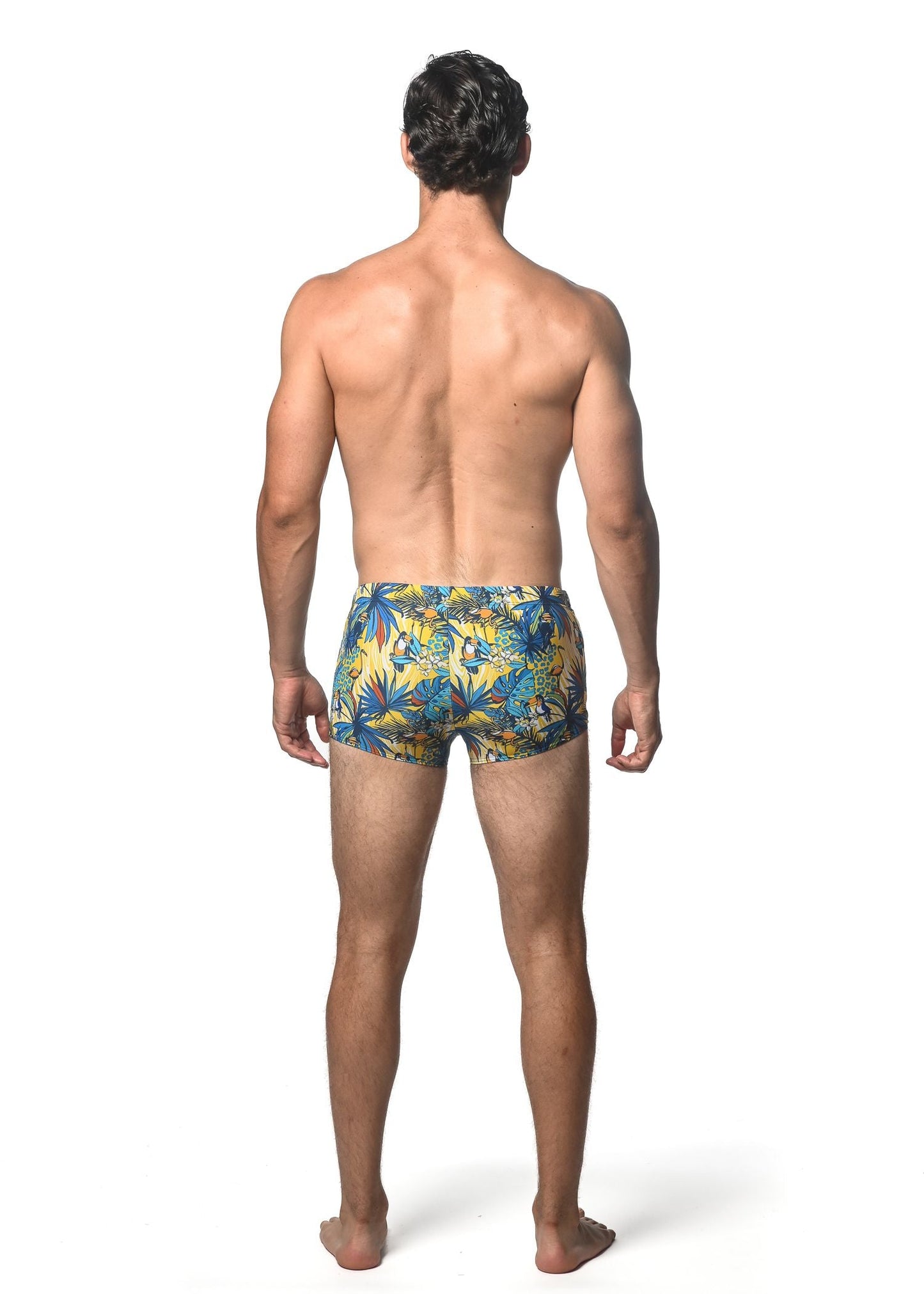 Men’s jungle printed swim trunks with vibrant yellow and blue tropical palm leaf pattern for beach and pool use