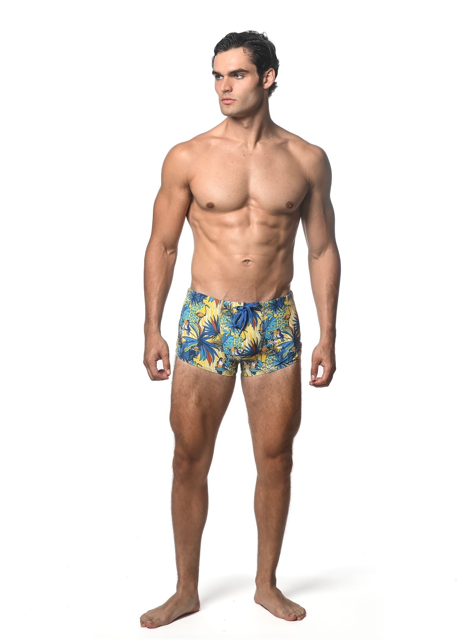 Men’s jungle printed swim trunk with vibrant tropical leaf pattern in blue and yellow for beachwear
