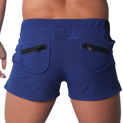 Royal blue short-length men’s athletic shorts with an elastic waistband and two back pockets featuring black zippers.