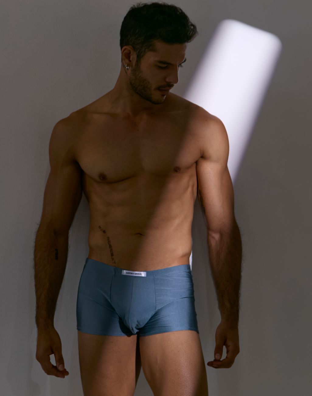 Blue cotton boxer briefs with a white brand label at the waistband from justin simon xsj08 classic metal green collection