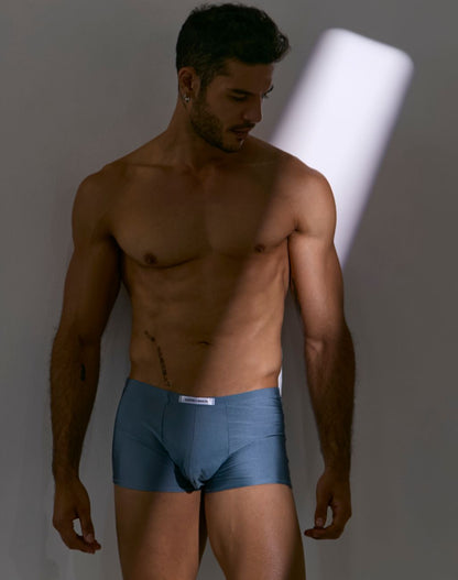 Blue cotton boxer briefs with a white brand label at the waistband from justin simon xsj08 classic metal green collection