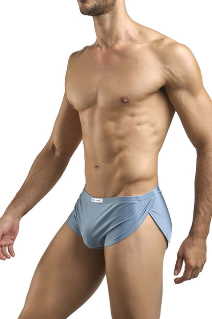 Light blue form-fitting briefs with subtle side slit and white brand tag on waistband in justin simon xsj09 running shorts metal green