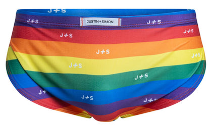 Rainbow-striped men’s briefs by Justin Simon with white repeating j plus s logo in pride flag colors for running use