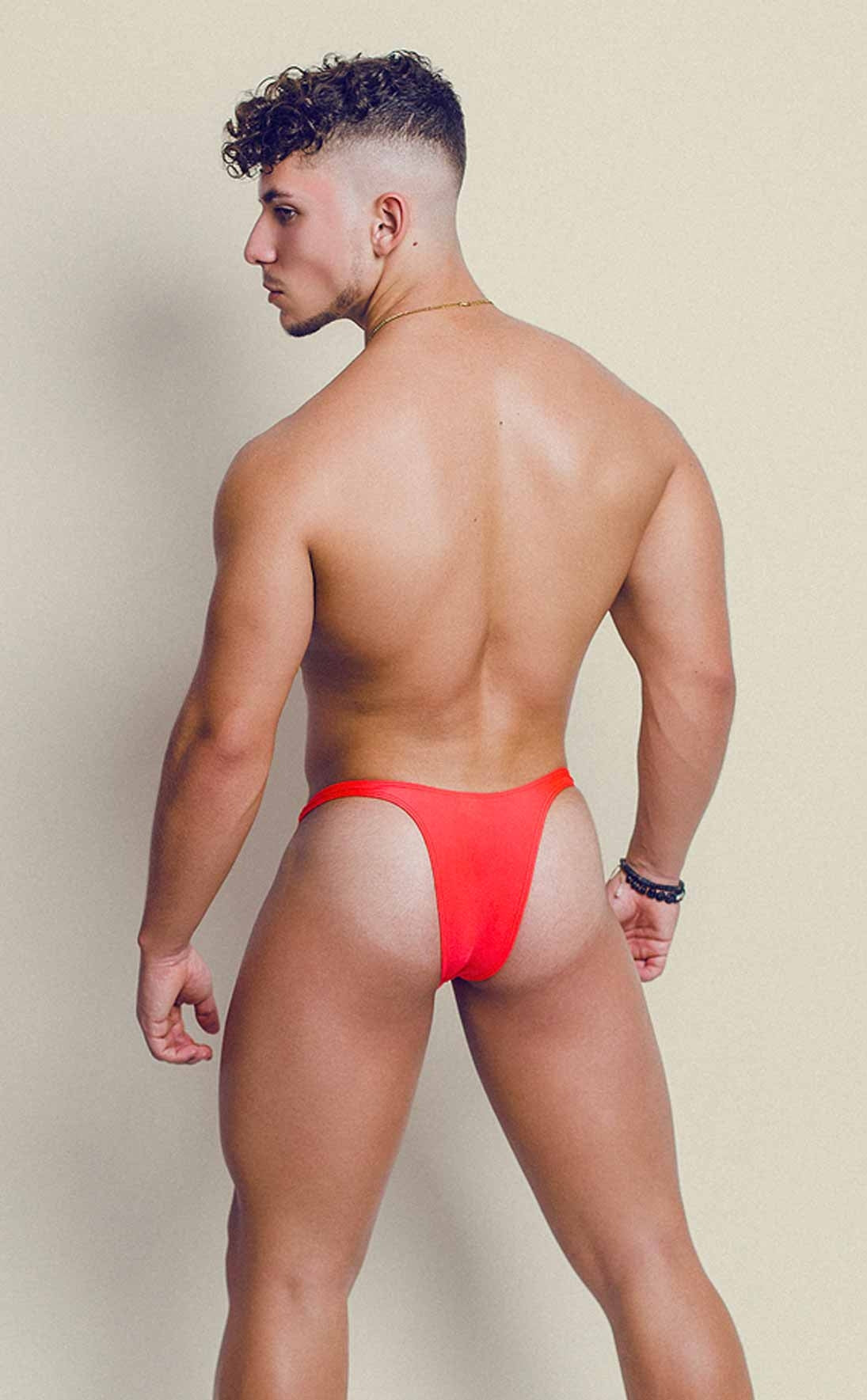 Vibrant red joe snyder polyester capri thong in smooth stretch fabric shown from the back side