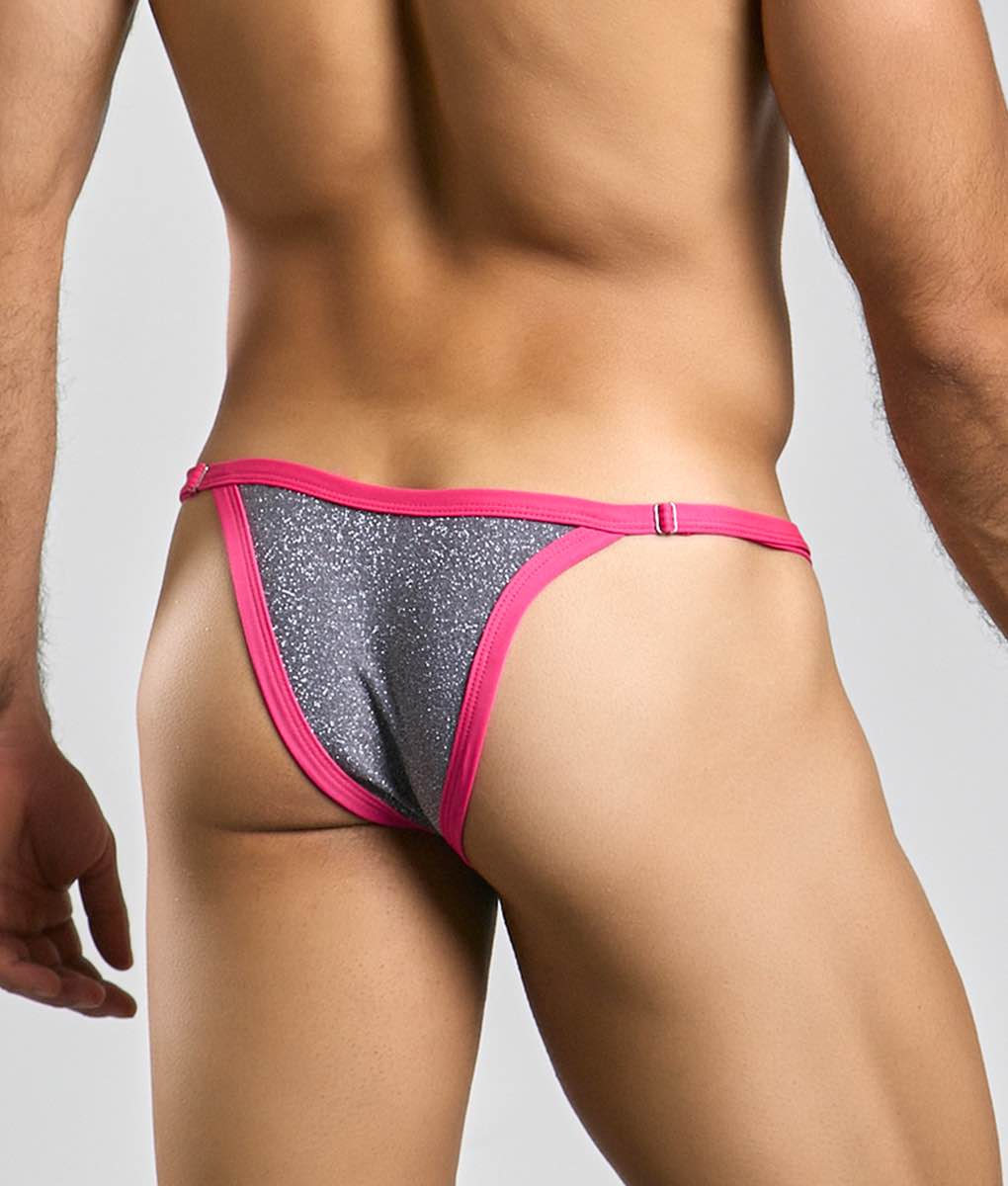 A vibrant pink and silver glitter thong with a snug form-fitting design from the justin + simon bikini one collection