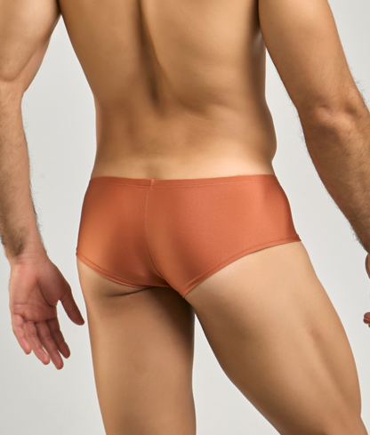 A sleek rust-orange justin simon cheeky bulge boxer with a smooth form-fitting design for comfortable wear