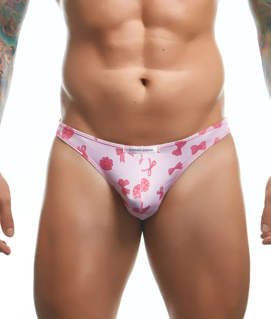 Pink patterned thong with bow and ribbon designs and white waistband labeled justin simon from Justin plus Simon classic tanga