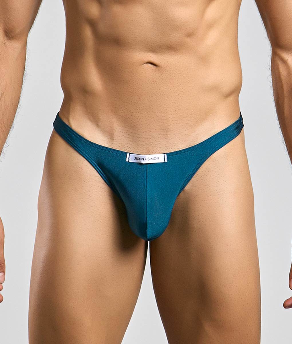 Teal-colored justin + simon classic tanga thong with a sleek form-fitting design shown from the front
