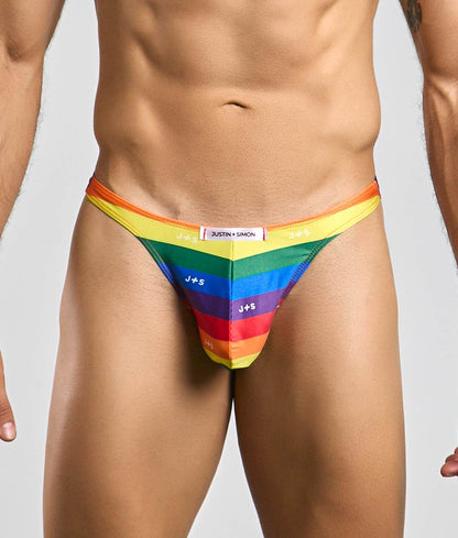 Rainbow-striped men’s thong by Justin + Simon featuring bold vibrant colors and sleek form-fitting design front view