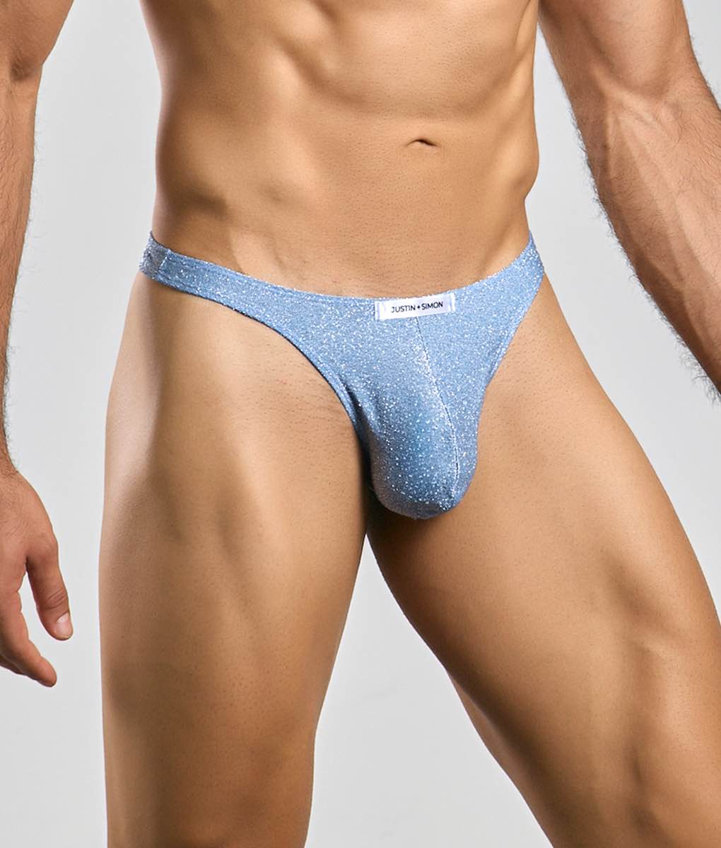 Light blue glittery classic tanga thong by Justin Simon with a white brand tag visible in the image