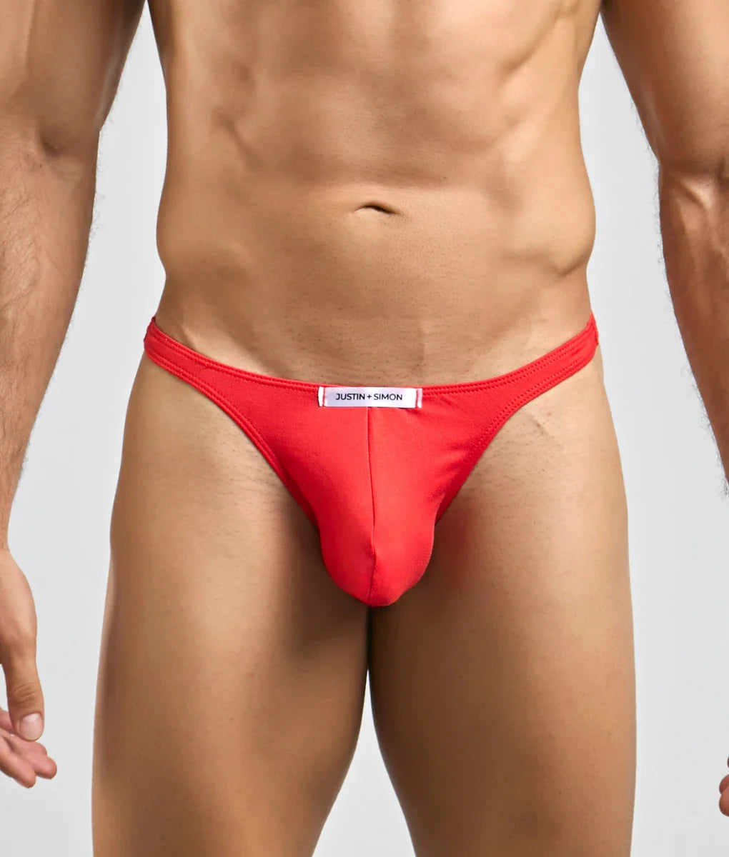 Red justin simon men’s sexy peachskin thong with white waistband label showing the back side of the product