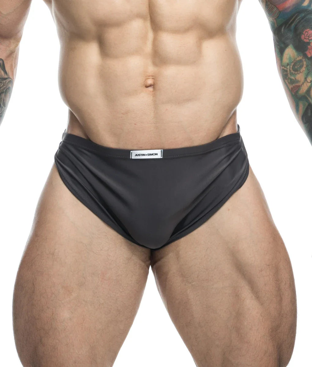 Black athletic briefs with sleek form-fitting design and white justin simon brand label on waistband for running use