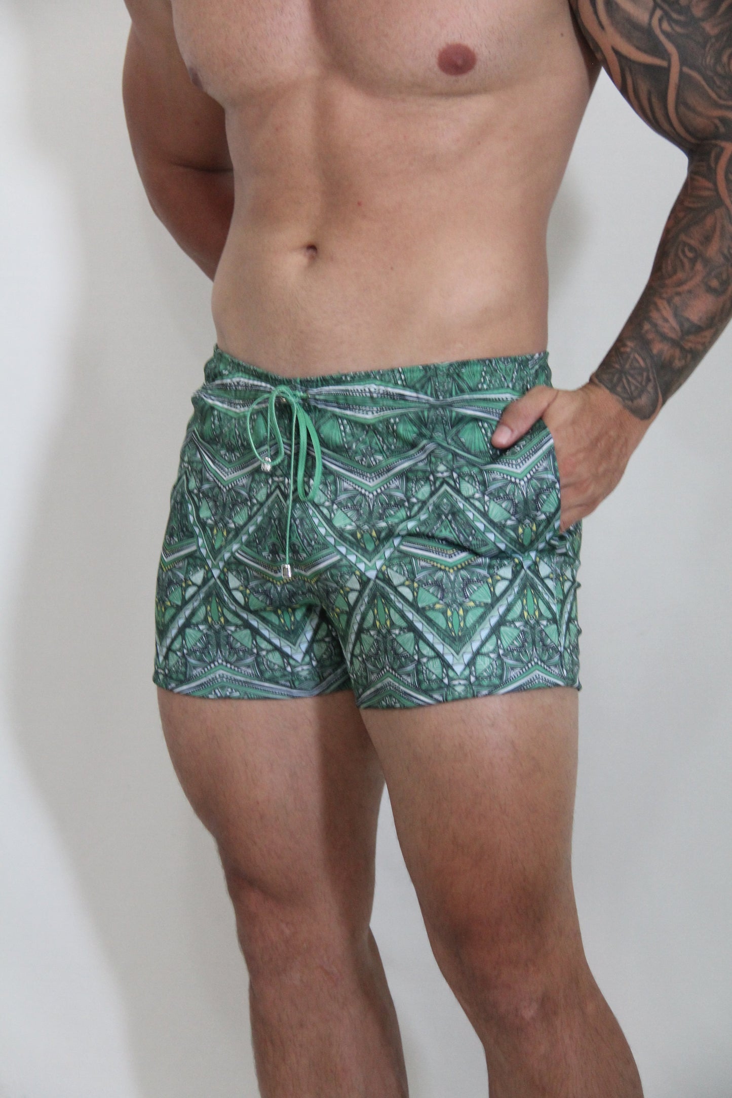 Kaleidoscope shorts green patterned swim trunks with geometric design and matching drawstring for beachwear