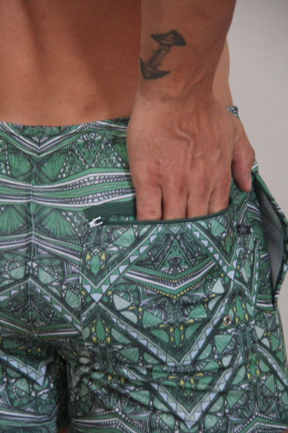Kaleidoscope shorts green patterned swim trunks with geometric and tribal designs in shades of green black white and yellow