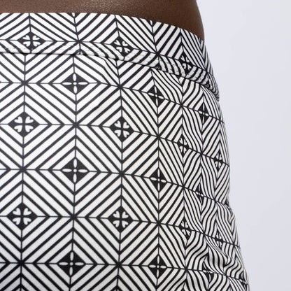 Black and white geometric-patterned kaleidoscope sq cut trunk skirt with bold repeating diamond design