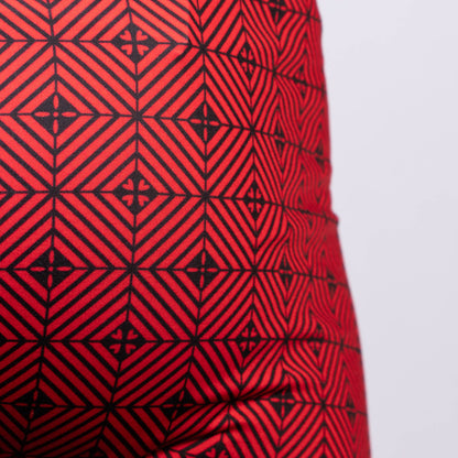 Red fabric of the Kaleidoscope sq cut trunk with a bold black geometric pattern of interlocking diamonds and cross motifs