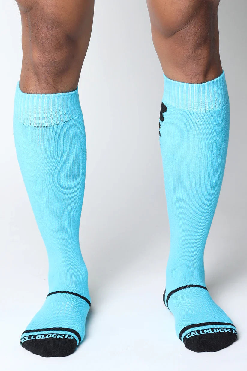 Light blue kennel club bones knee high socks with black trim black logo and white cellblock13 branding on sole