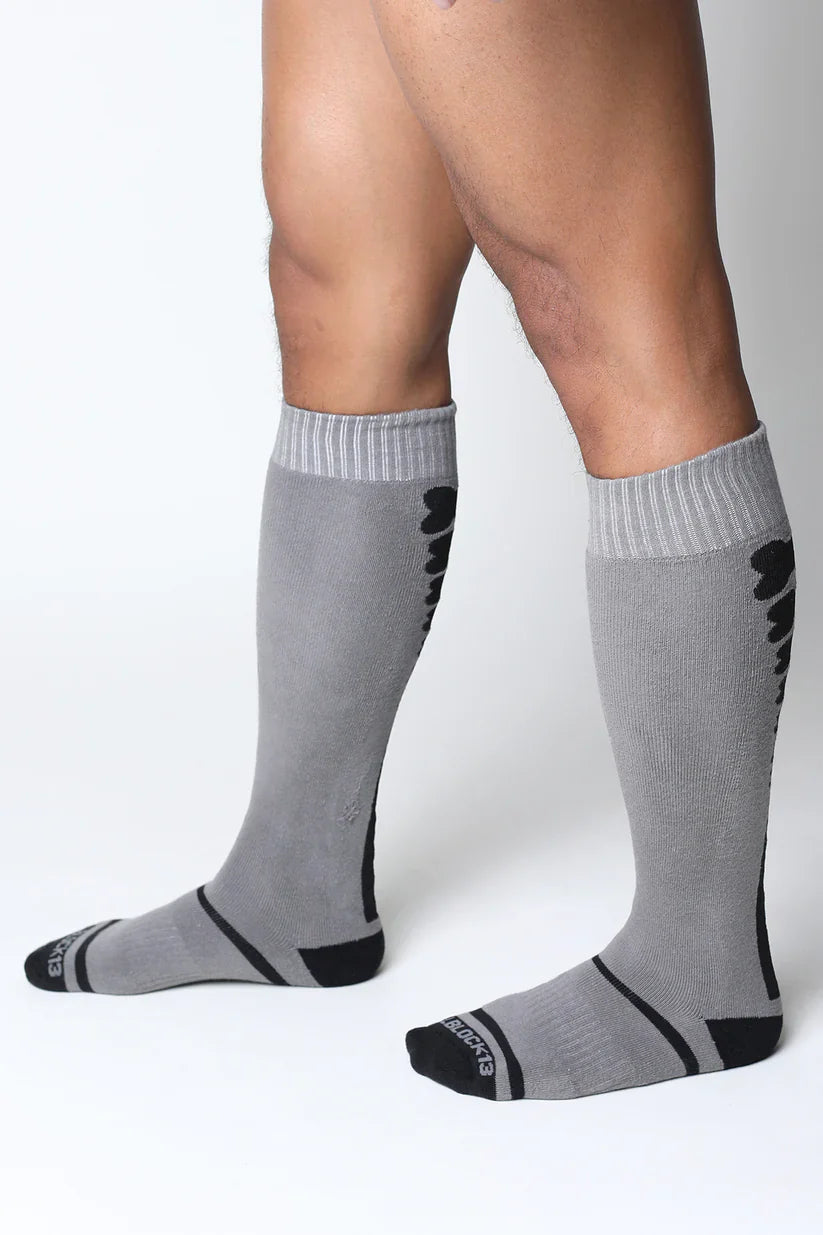Kennel club bones knee high socks in gray with black accents ribbed cuffs and a subtle textured pattern