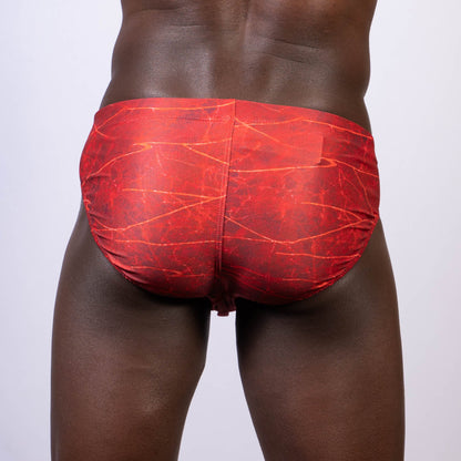 Red swim trunks with a marbled pattern featured in the lightning swim brief for stylish beachwear