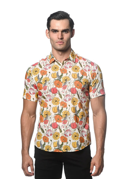 A man wearing a lightweight cotton tencel short-sleeved shirt with vibrant orange yellow pink and white floral pattern on off-white