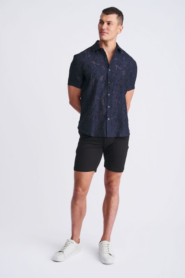 A navy blue lightweight jacquard short-sleeved button-up shirt with a subtle floral pattern