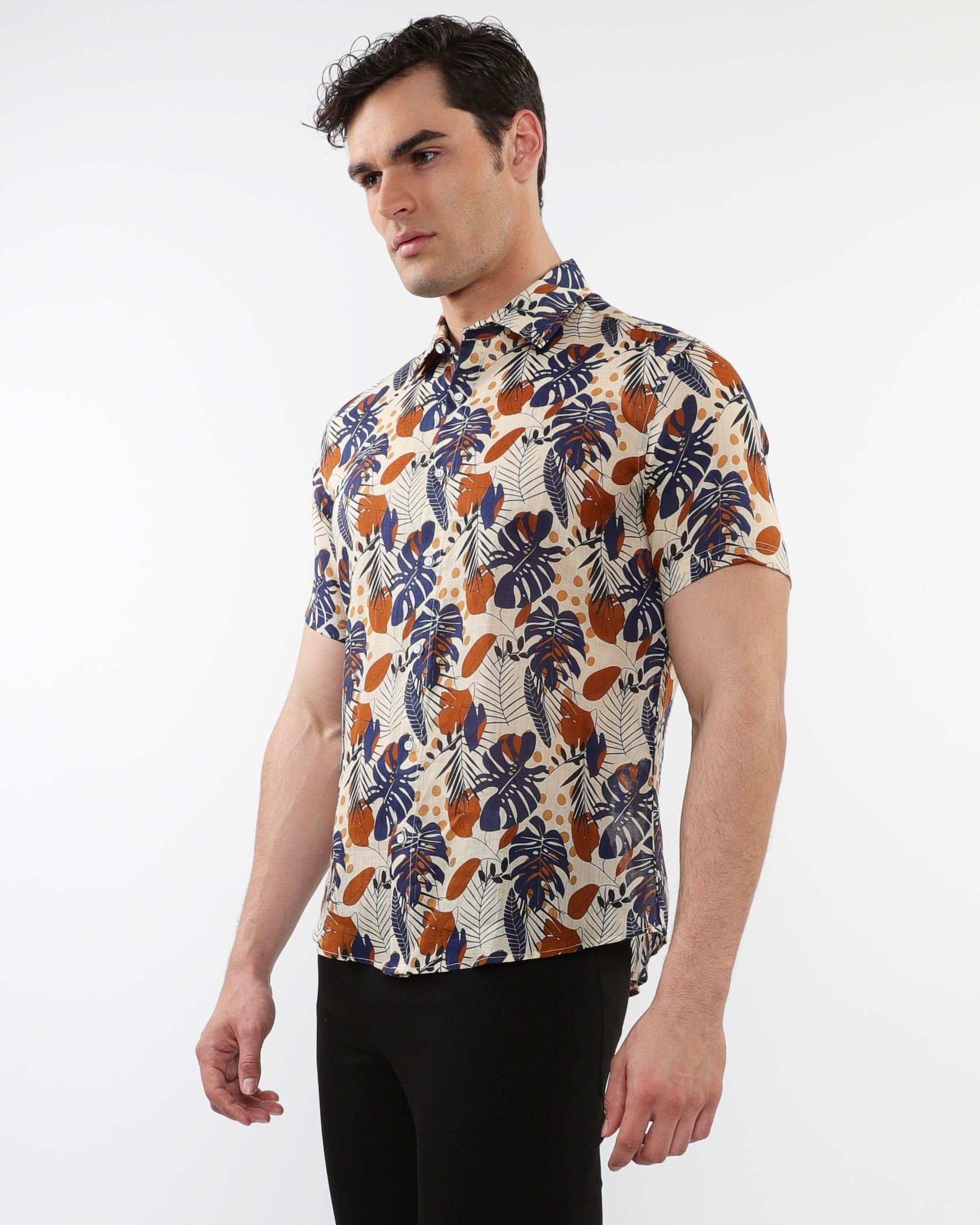 Lightweight linen tencel short-sleeved shirt with navy blue burnt orange tropical leaf pattern on beige fabric