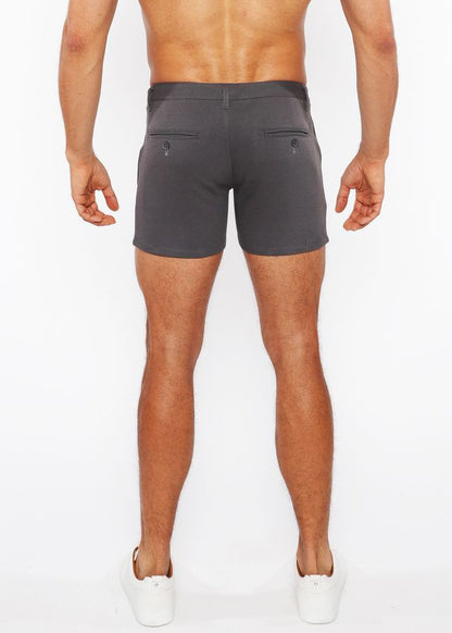 Dark gray linen-look textured tailored shorts shown from the back with two buttoned zip pockets