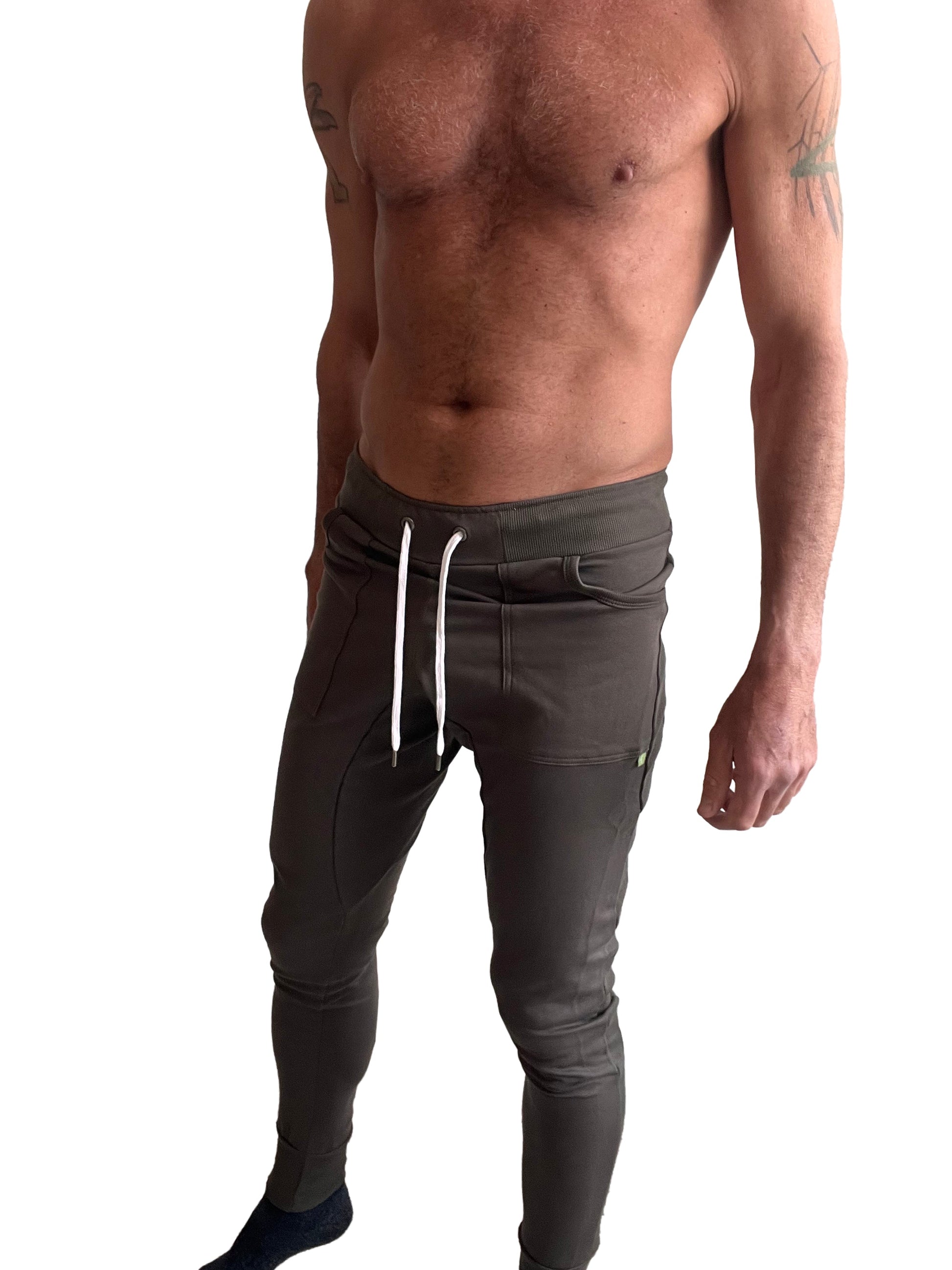 Dark olive green long cuffed jogger and yoga sweat pants with white drawstrings and a sleek form-fitting design
