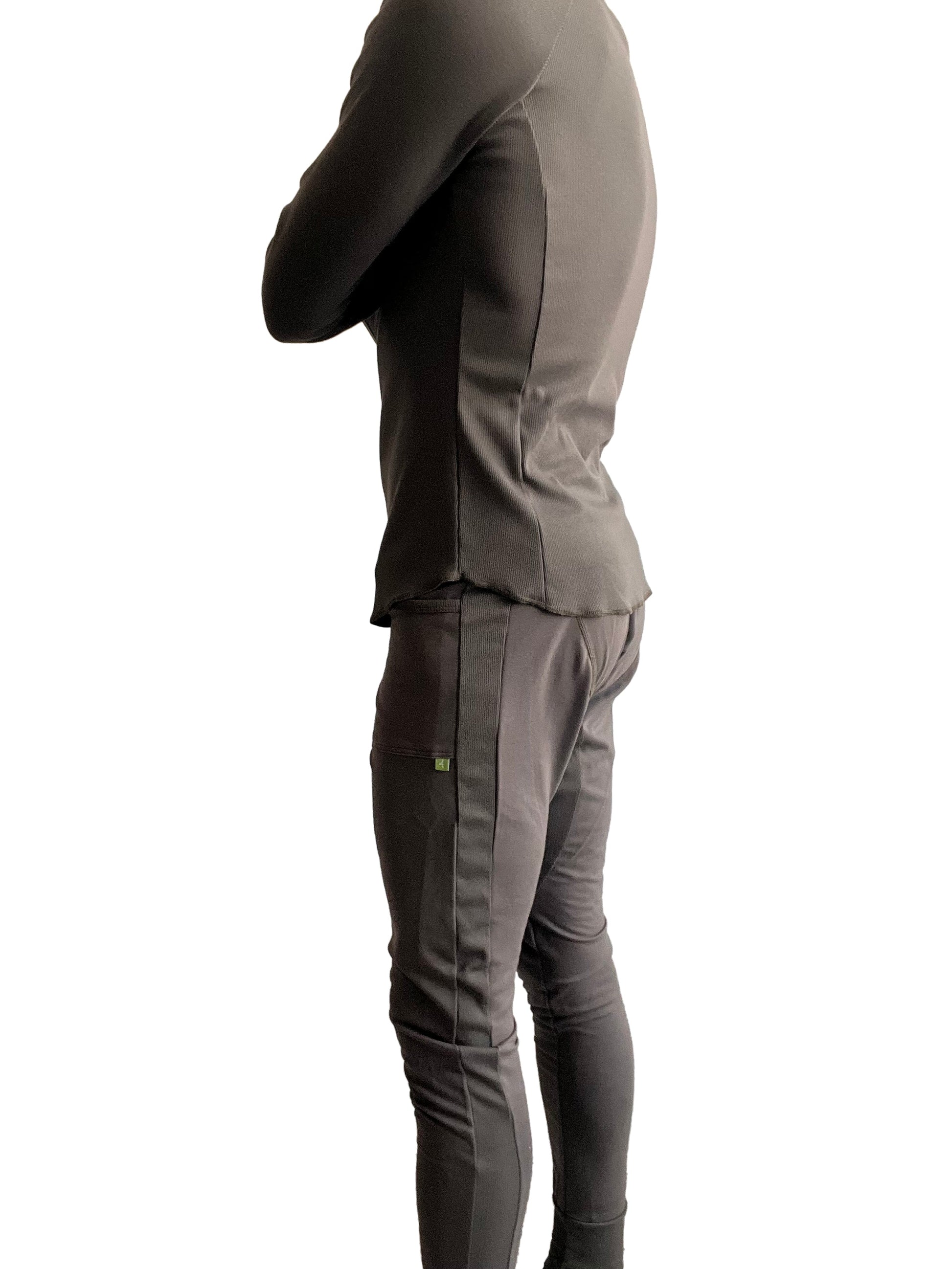 Charcoal-gray two-piece athletic set with fitted long-sleeve top and slim-fit jogger pants with vertical seams