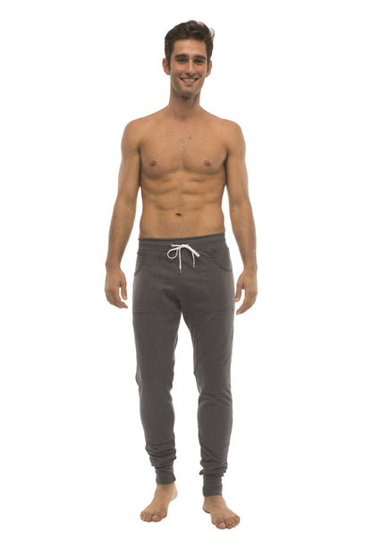 Dark gray long cuffed jogger and yoga sweat pants with white drawstring waistband and elastic cuffs for comfort
