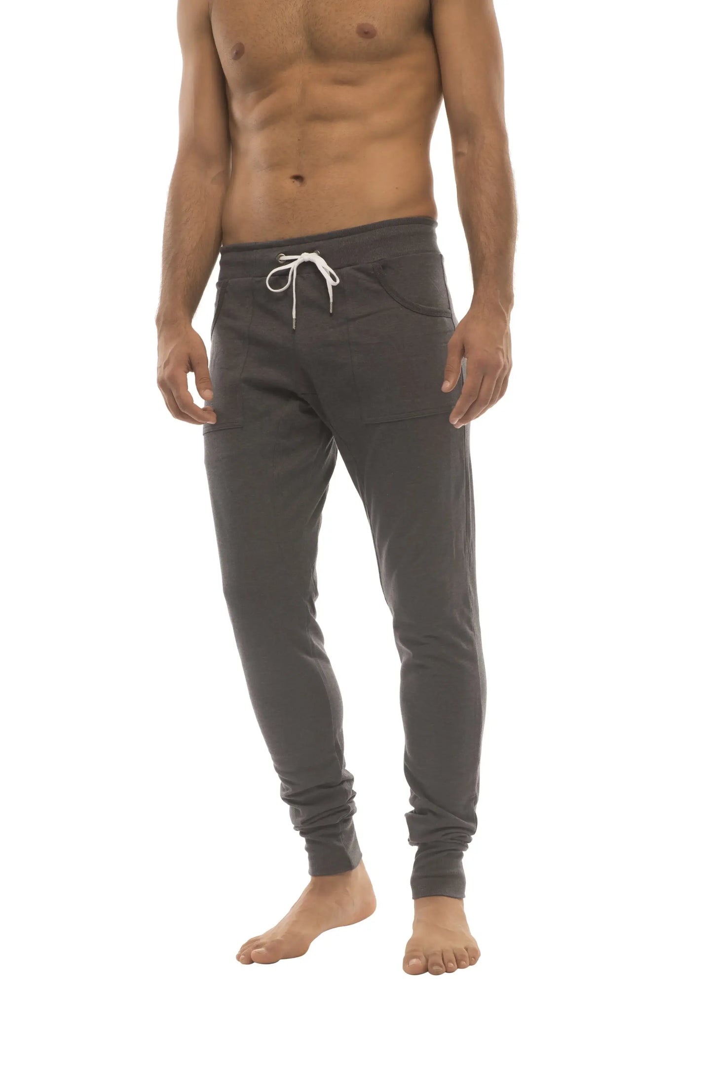 Dark gray long cuffed jogger and yoga sweat pants featuring a white drawstring waistband and elastic cuffs