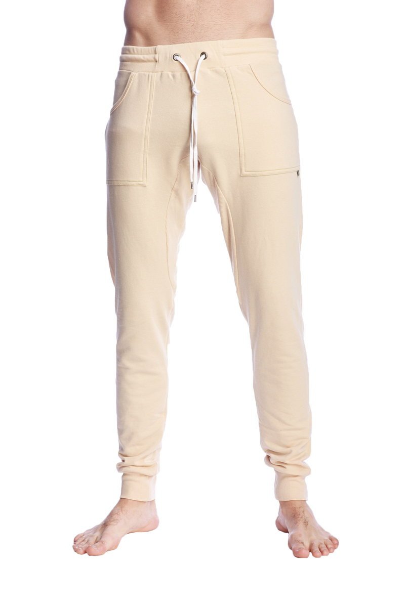 Cream-colored long cuffed jogger and yoga sweat pants in sand beige with drawstring waist and side pockets