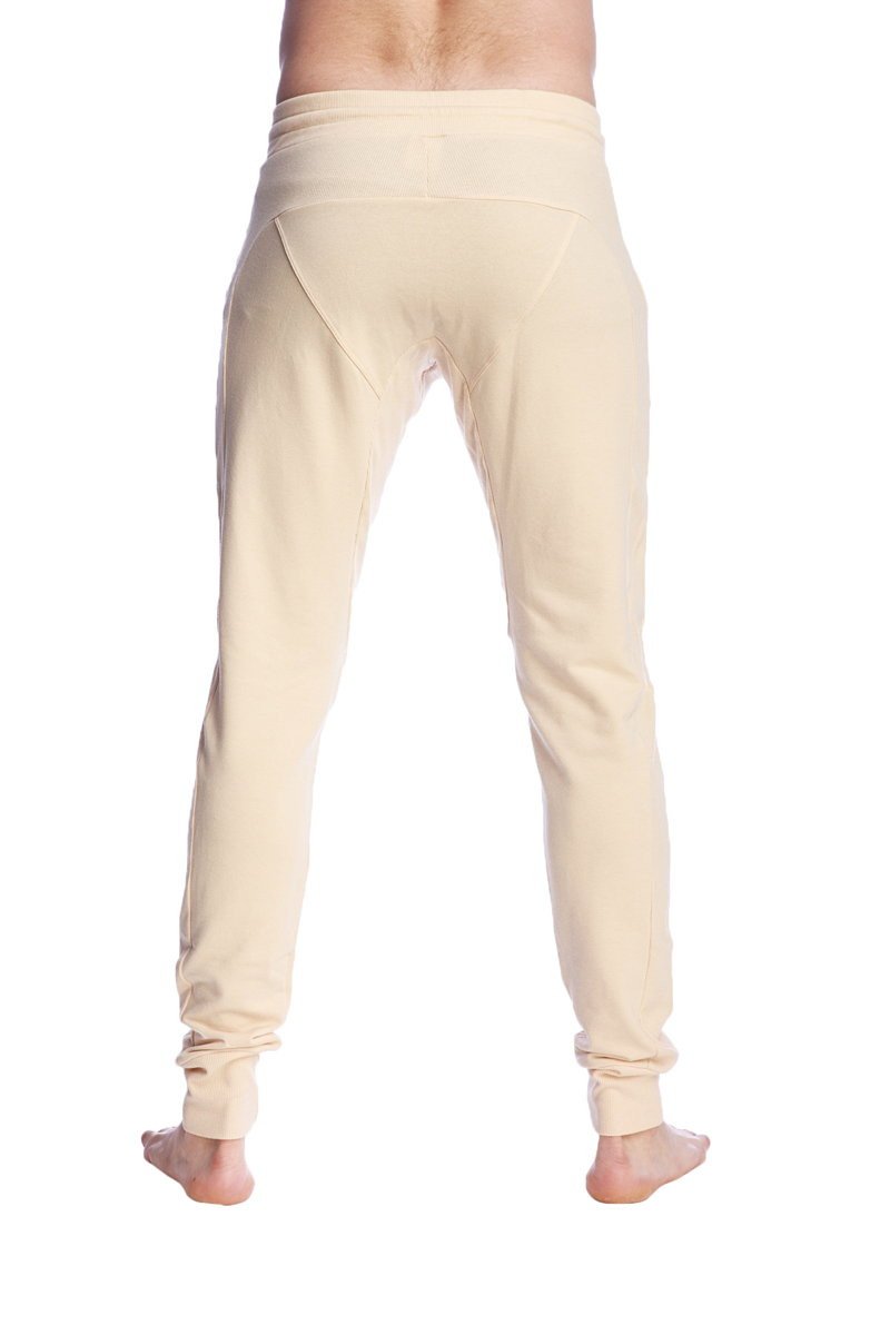 Cream-colored stretchy long cuffed jogger and yoga sweat pants in sand beige with tapered fit and rolled cuffs