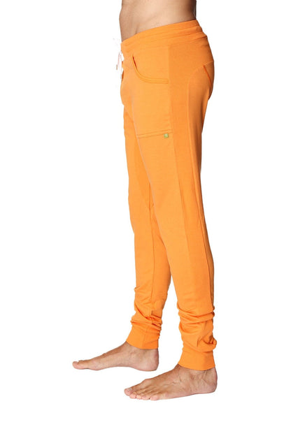 Long cuffed jogger and yoga sweat pants in sun orange with soft fabric, drawstring waist, and rolled cuffs