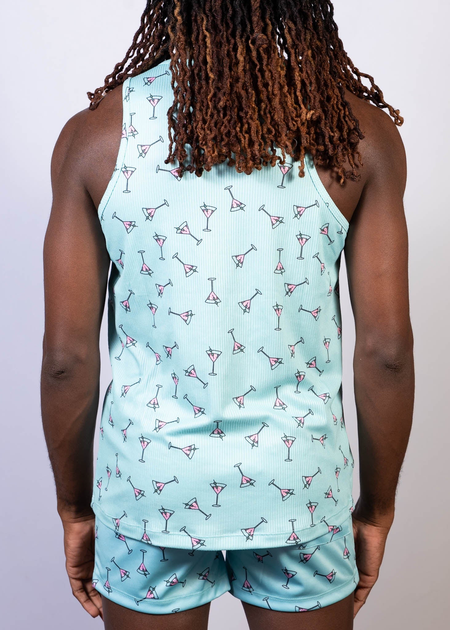 Light blue tank top with a repeating pattern of pink and black martini glasses called martini print tank