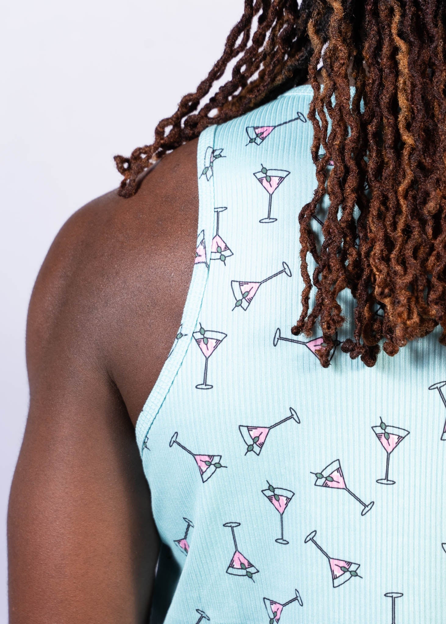 Light blue ribbed tank top with playful pink martini glass pattern outlined in black martini print tank