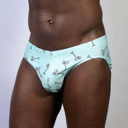 Mint green swim brief featuring playful pink martini glass pattern ideal for stylish beach and pool wear