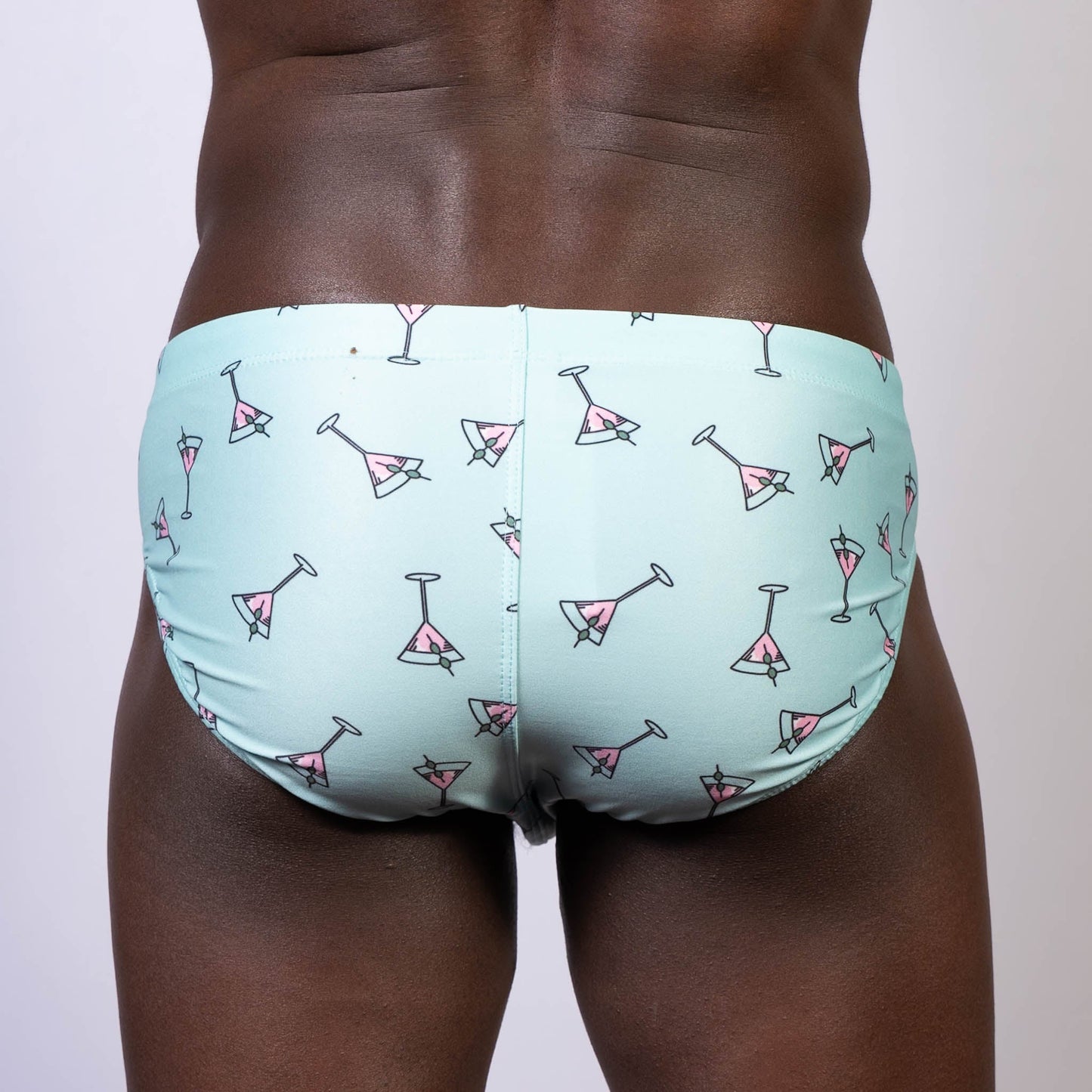 Light blue martini swim brief with pink martini glass pattern perfect for beach and poolwear
