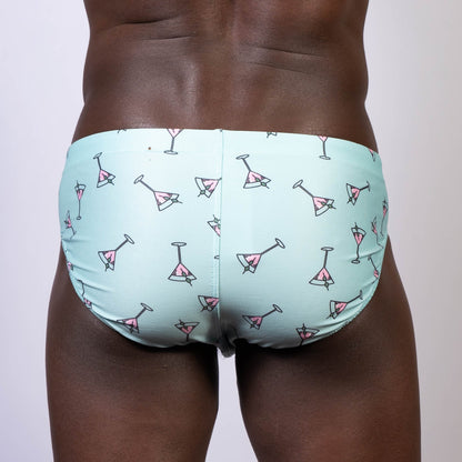 Light blue martini swim brief with pink martini glass pattern perfect for beach and poolwear