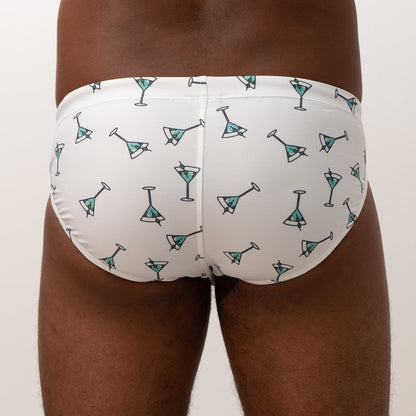White martini swim brief featuring a playful teal martini glass pattern with black outlines for beachwear