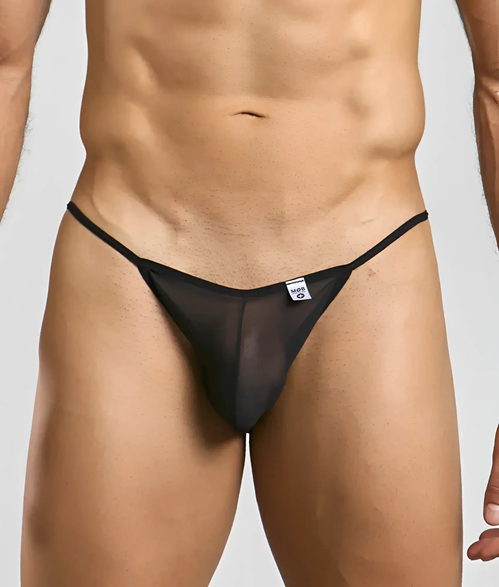 Black sheer mesh thong with thin elastic waistband and small white brand tag from mob men’s sheer bikini collection
