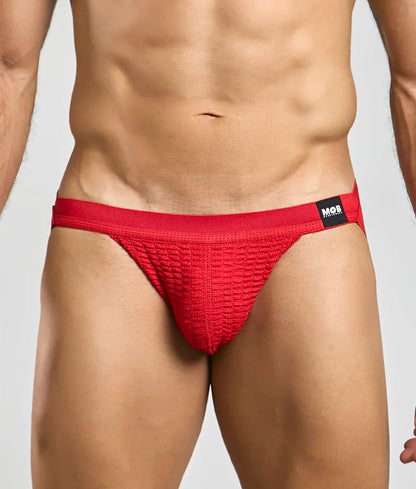 Red textured swim jockstrap briefs with a black mob brand tag on the waistband for swimwear use